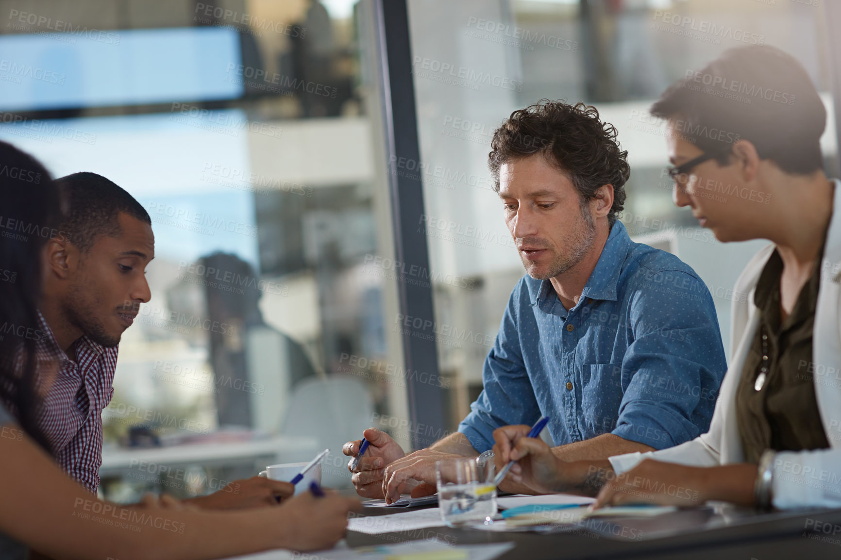 Buy stock photo Cropped shot of a group of colleagues meeting in the office