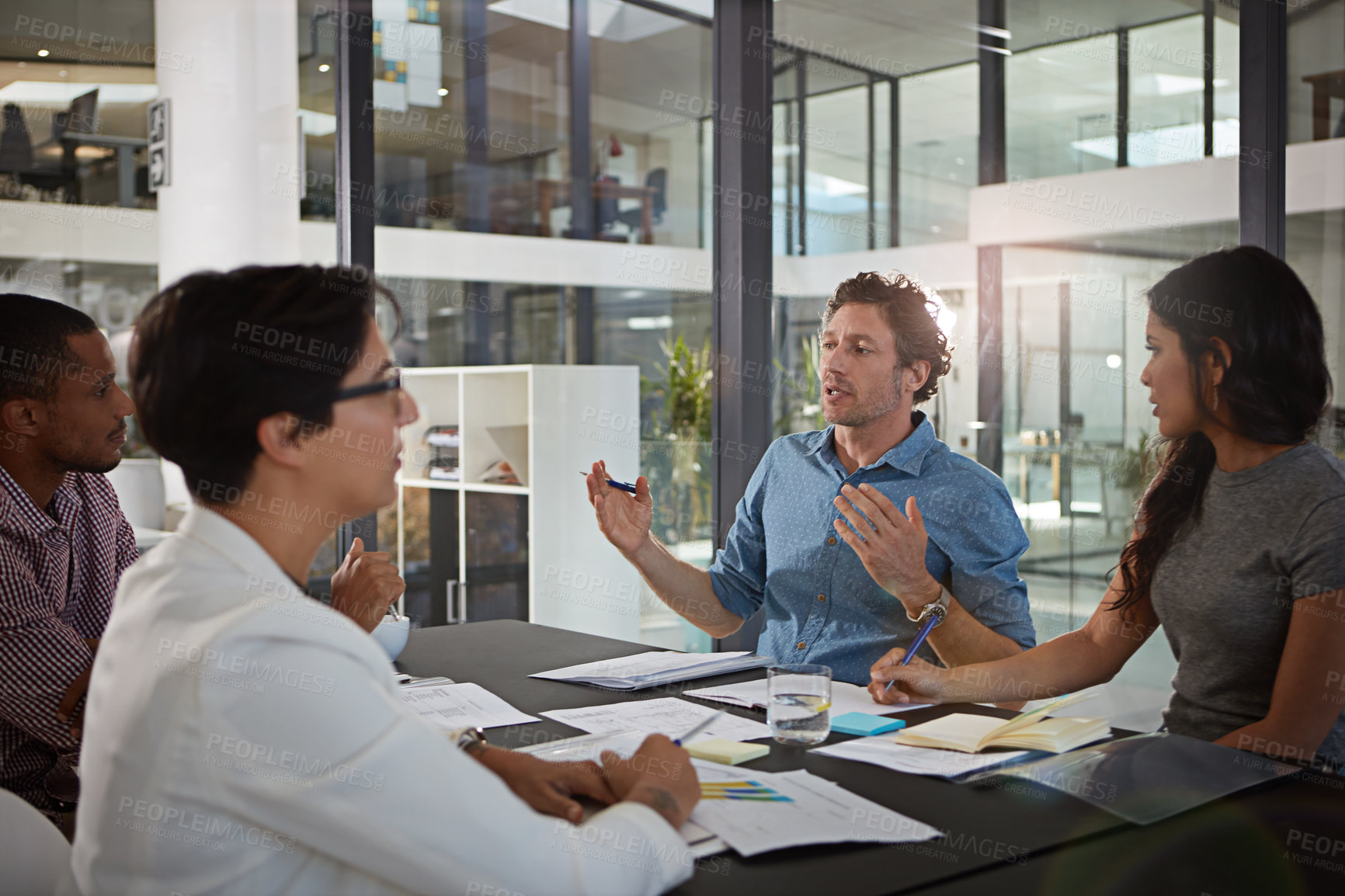 Buy stock photo Cropped shot of a group of colleagues meeting in the office