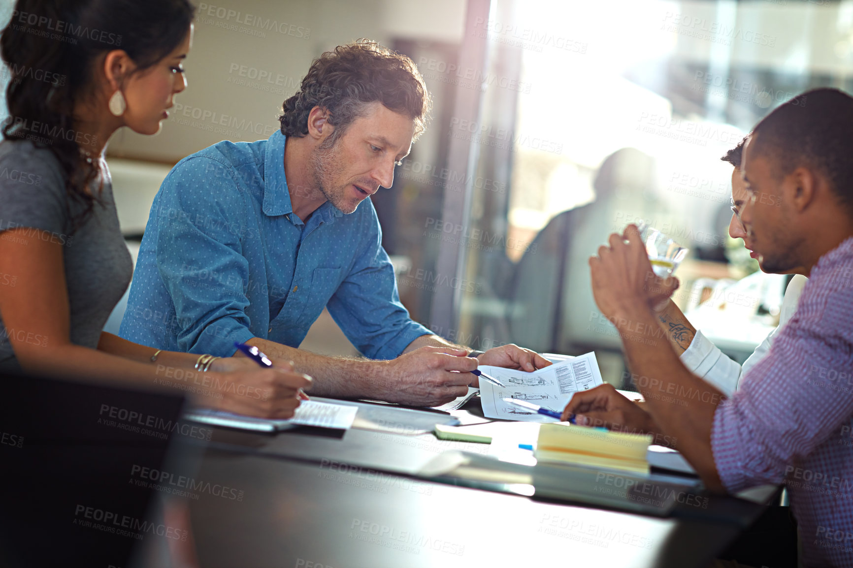 Buy stock photo Cropped shot of a group of colleagues meeting in the office