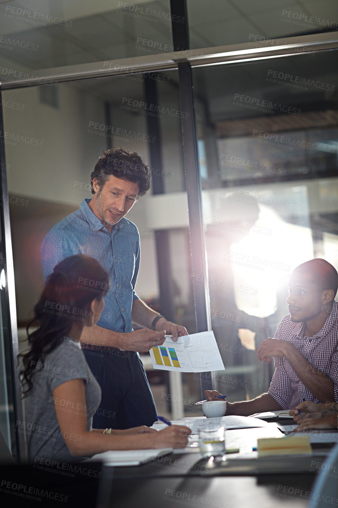 Buy stock photo Cropped shot of a group of colleagues meeting in the office