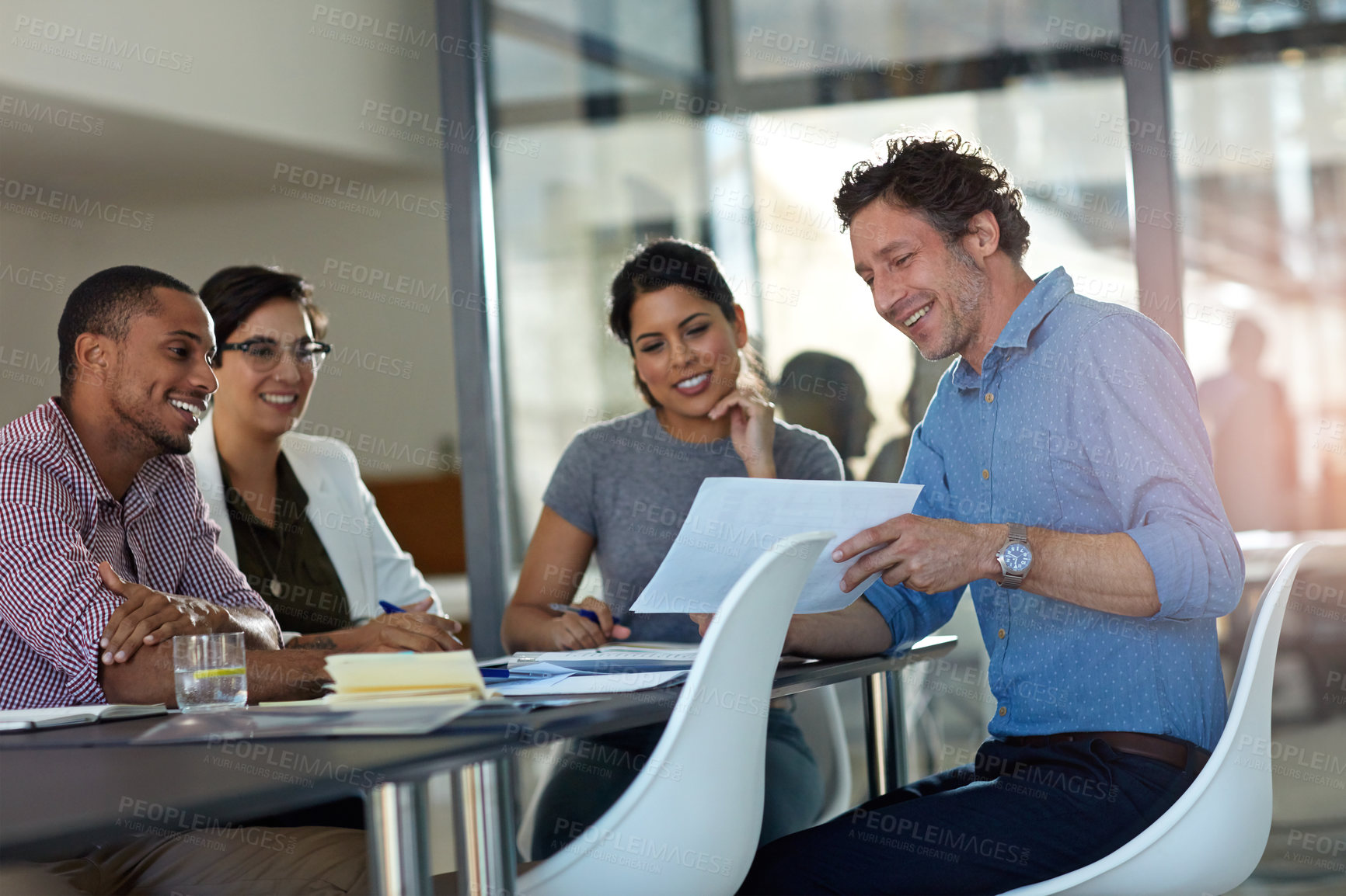 Buy stock photo Cropped shot of a group of colleagues meeting in the office