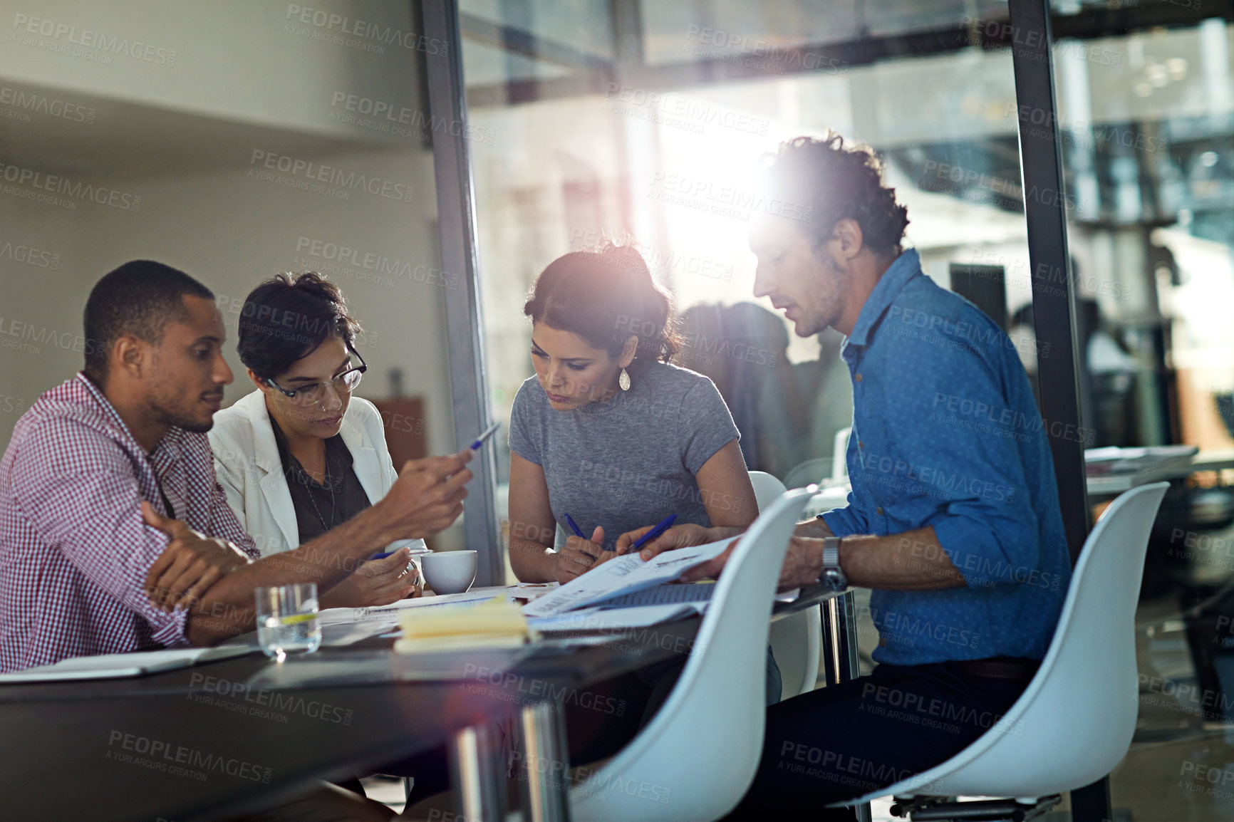 Buy stock photo Cropped shot of a group of colleagues meeting in the office