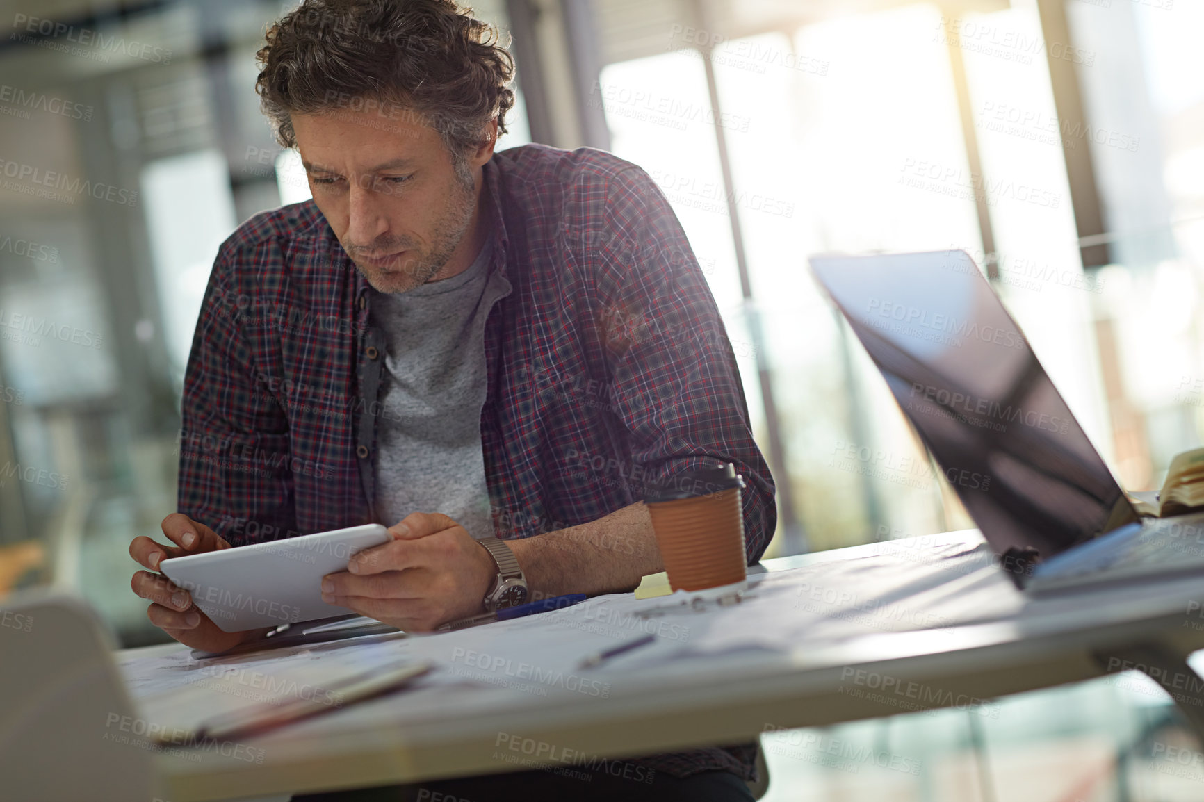 Buy stock photo Cropped shot of a businessman working in his office