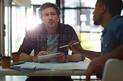 Buy stock photo Cropped shot of two businessmen talking in the office