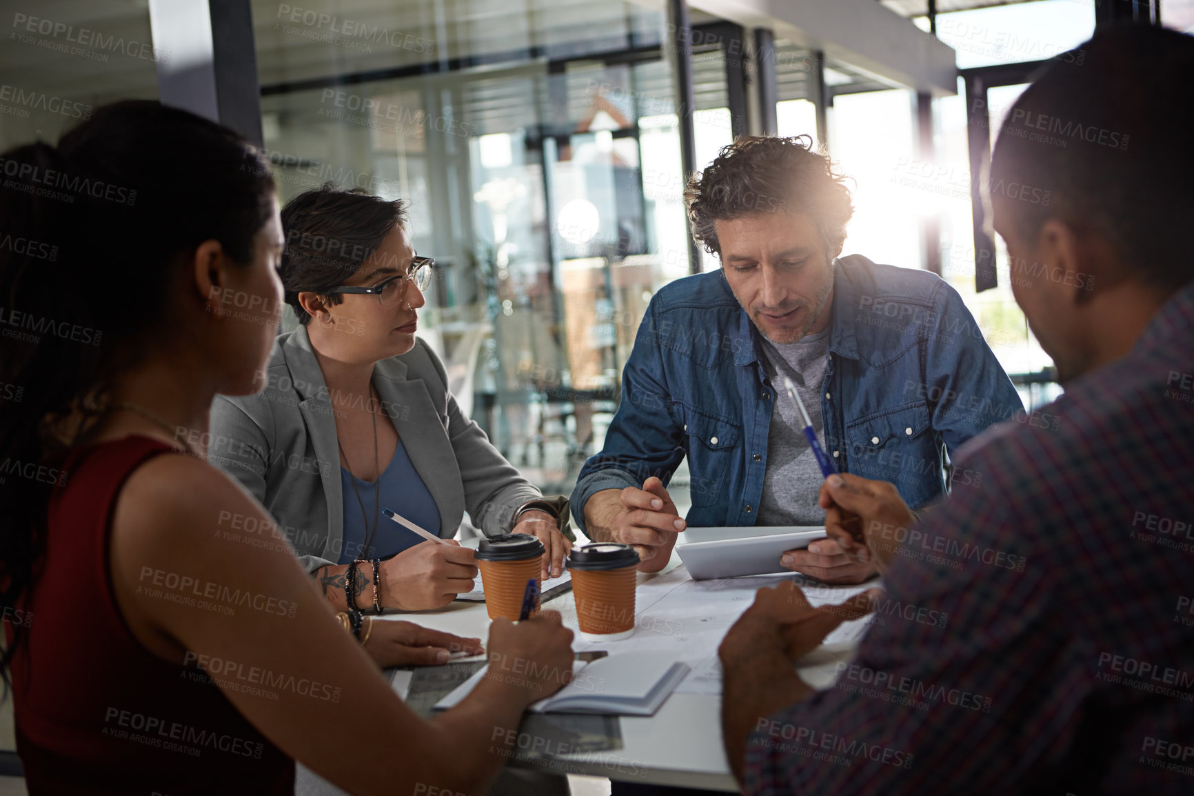 Buy stock photo Business people, paperwork and diversity in collaboration, meeting or feedback as creative in office. Group, document and discussion for teamwork, digital agency and mentorship in employee engagement