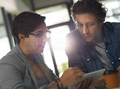 Buy stock photo Cropped shot of two business colleagues meeting in the office