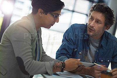 Buy stock photo Cropped shot of two business colleagues meeting in the office