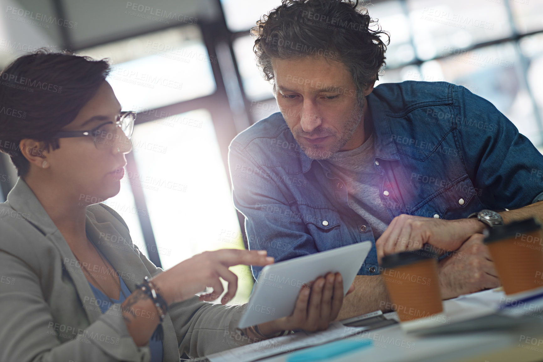 Buy stock photo Cropped shot of two business colleagues meeting in the office