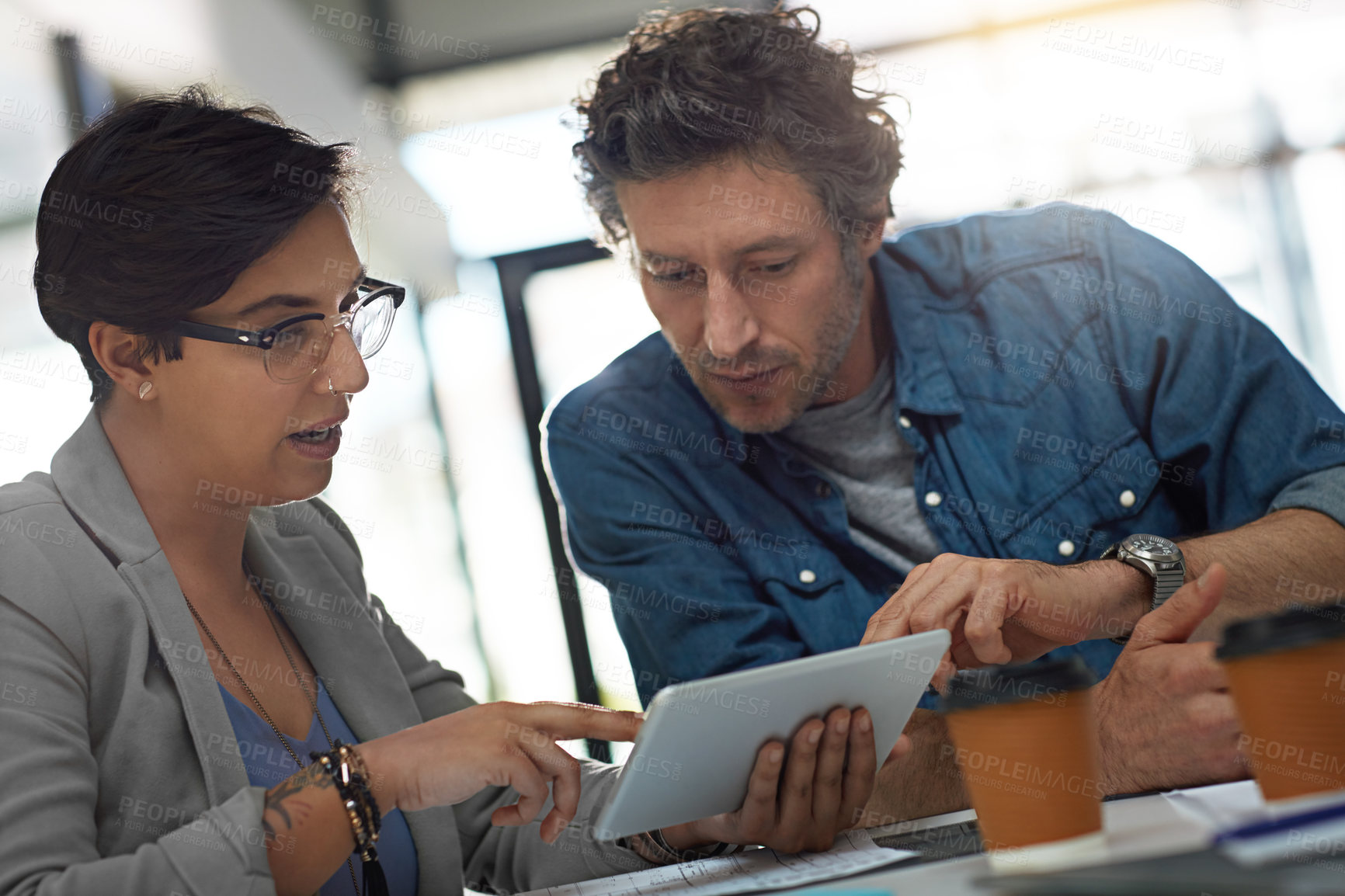 Buy stock photo Cropped shot of two business colleagues meeting in the office