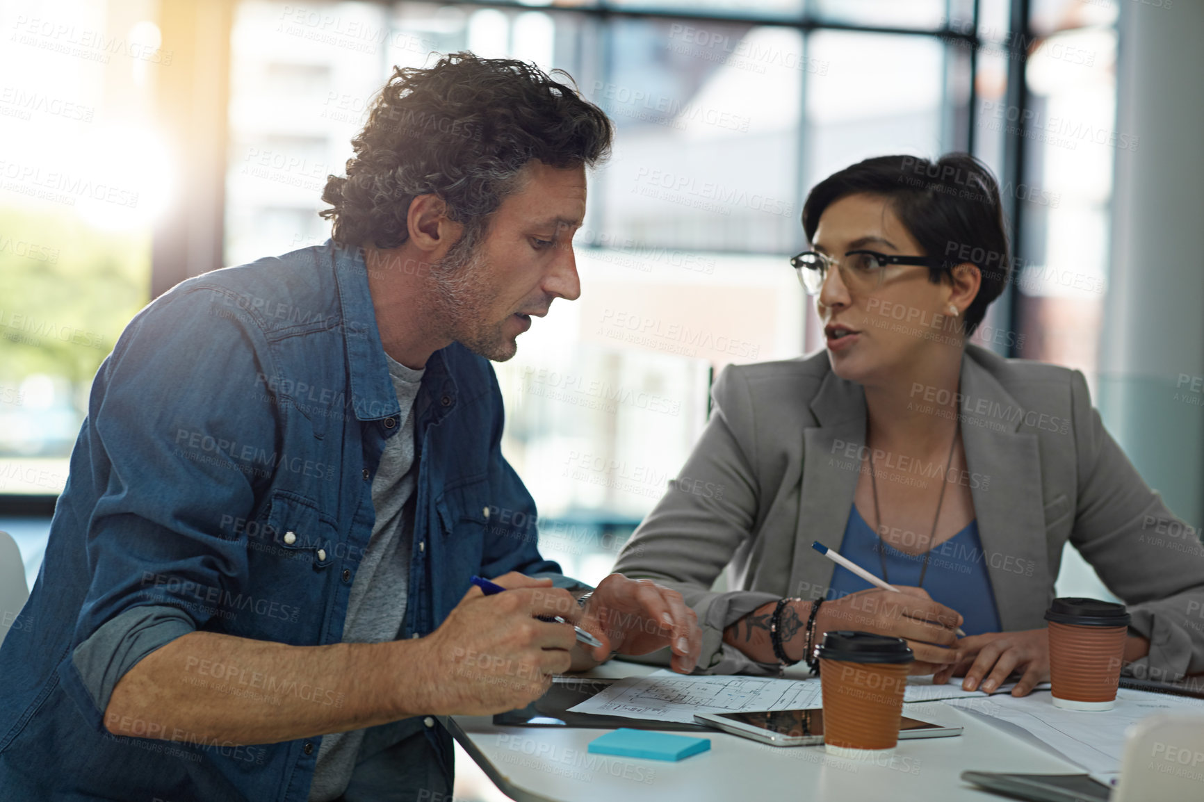 Buy stock photo Cropped shot of two business colleagues meeting in the office