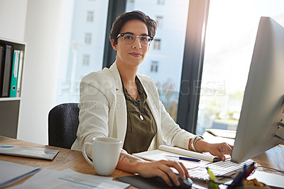 Buy stock photo Portrait of a businesswoman working on a computer in an office