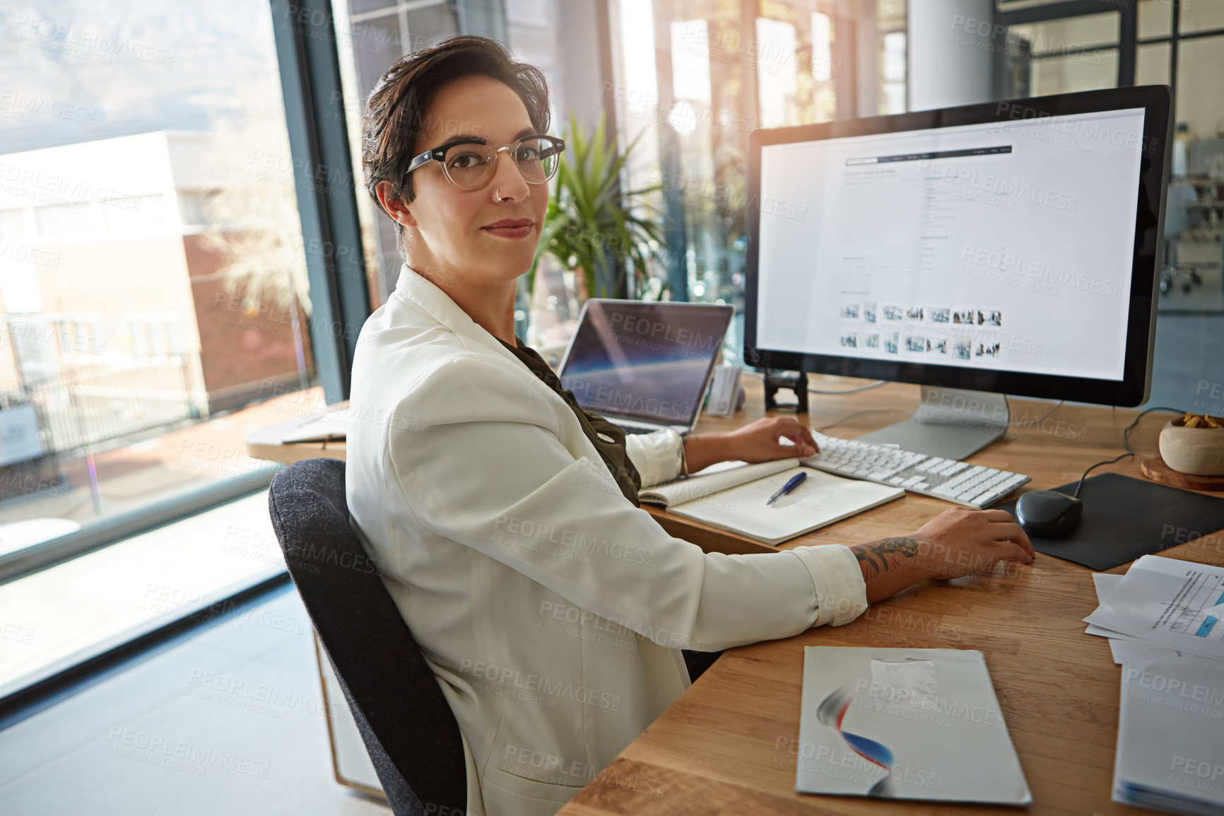 Buy stock photo Portrait of a businesswoman working on a computer in an office