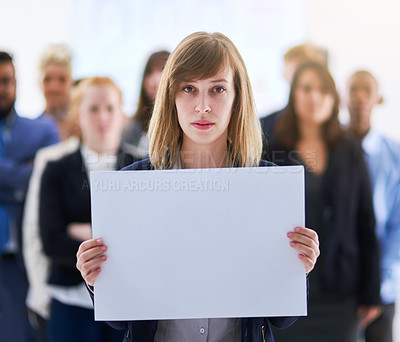 Buy stock photo Portrait of a businesswoman holding a blank board with colleagues standing behind her
