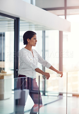 Buy stock photo Shot of a young businesswoman standing in an office