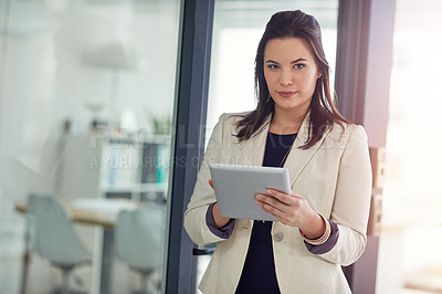 Buy stock photo Portrait of a young businesswomen using a digital tablet in an office