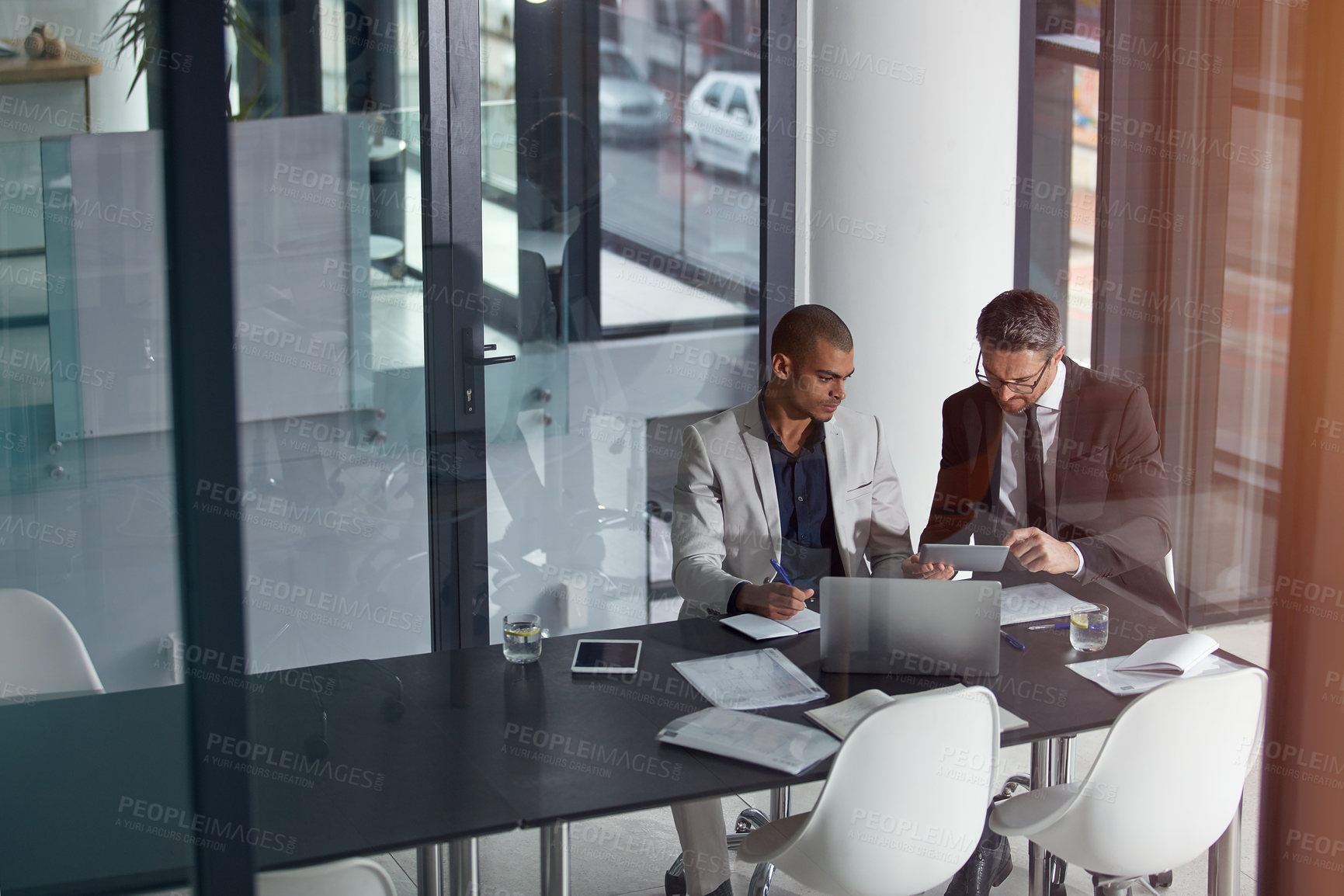 Buy stock photo Business people, talking and planning online for corporate strategy or partnership with teamwork. Men together in a meeting discussion with documents, paperwork and laptop at management table