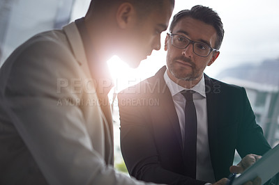 Buy stock photo Shot of two businessmen having an office meeting