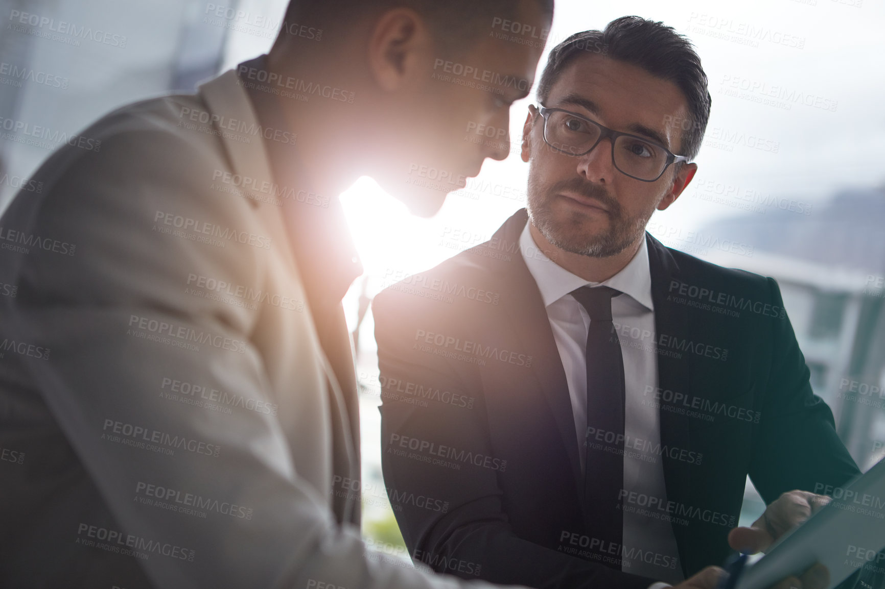 Buy stock photo Shot of two businessmen having an office meeting