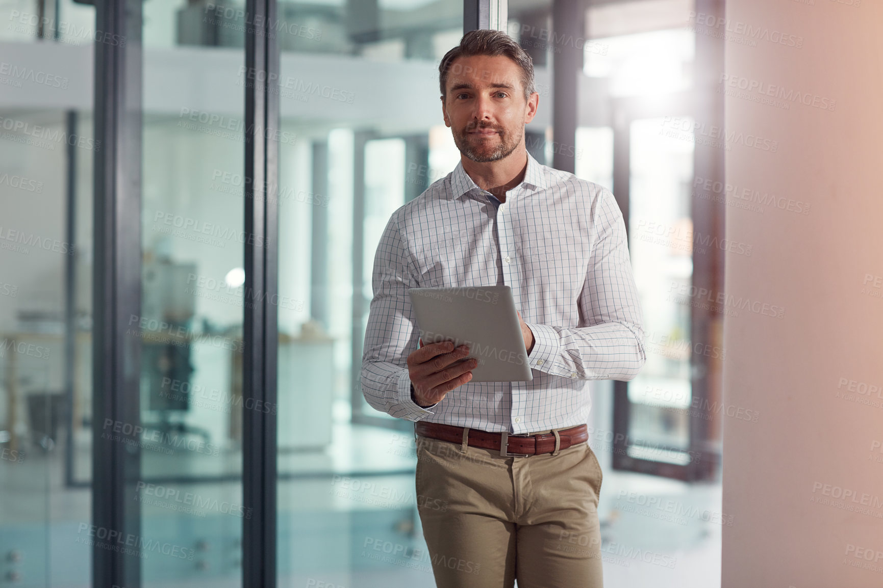 Buy stock photo Portrait of a businessman using a digital tablet in an office