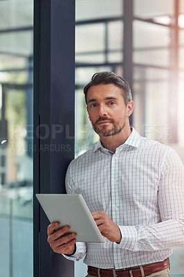 Buy stock photo Portrait of a businessman using a digital tablet in an office