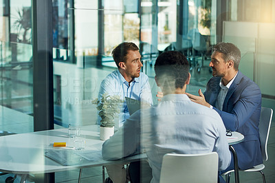 Buy stock photo Shot of businessmen having an office meeting