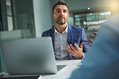 Buy stock photo Laptop, meeting and interview with a business man talking to a candidate for the hiring or recruitment process. Computer, feedback or review with a male employee sitting in a human resources office