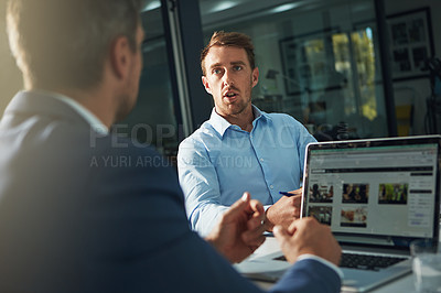 Buy stock photo Shot of two businessmen having an office meeting