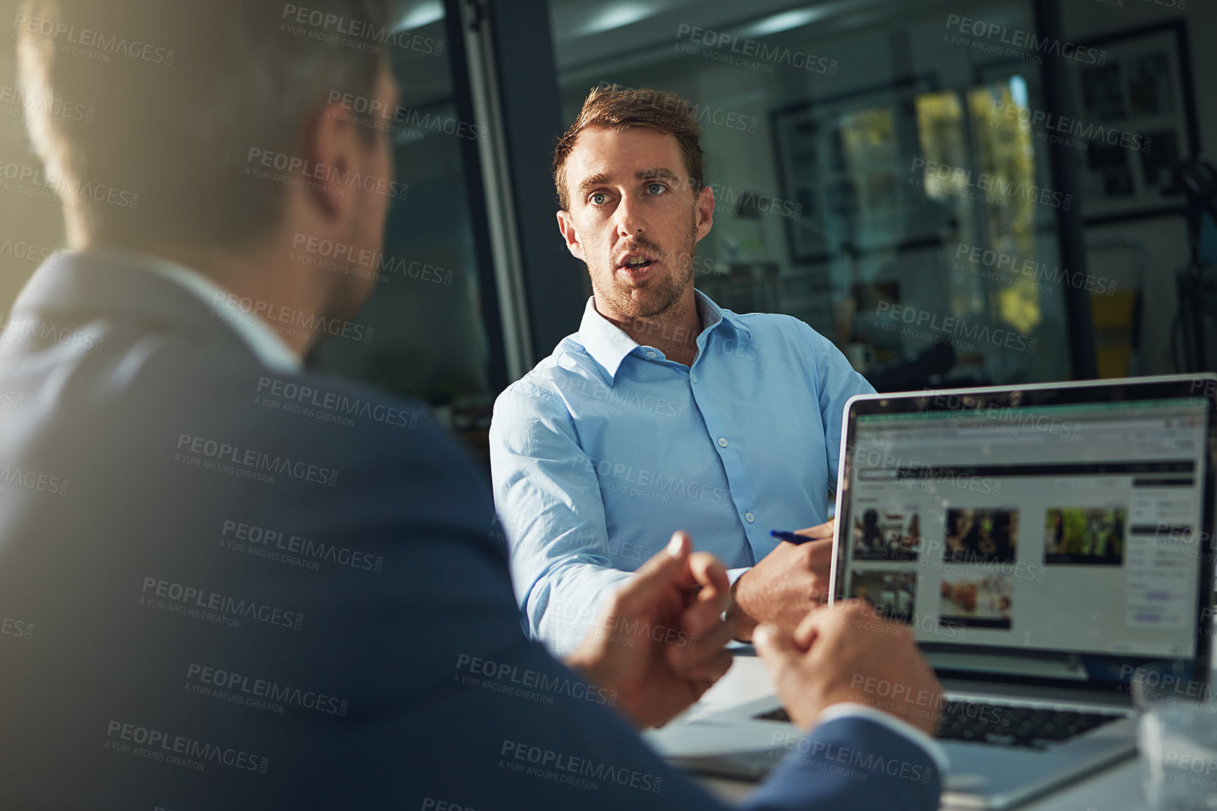 Buy stock photo Shot of two businessmen having an office meeting