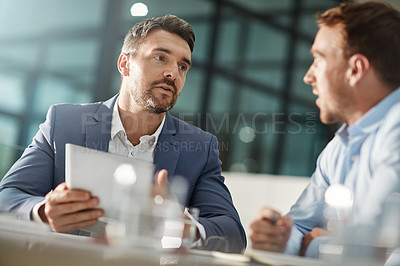 Buy stock photo Cropped shot of two businessmen meeting in the office