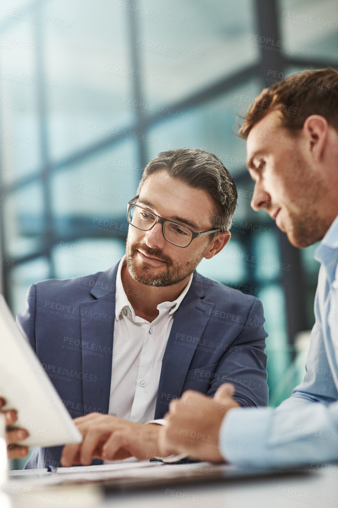 Buy stock photo Cropped shot of two businessmen meeting in the office