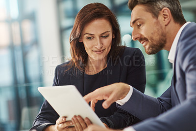 Buy stock photo Tablet, meeting or planning with a business man and woman in the office for research on a company project. Collaboration, technology and brainstorming with corporate team talking strategy at work