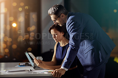 Buy stock photo Shot of a coworkers using a smartphone while woking late in the office