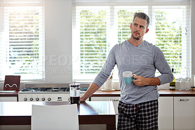 Buy stock photo Shot of a man drinking coffee in the morning at home