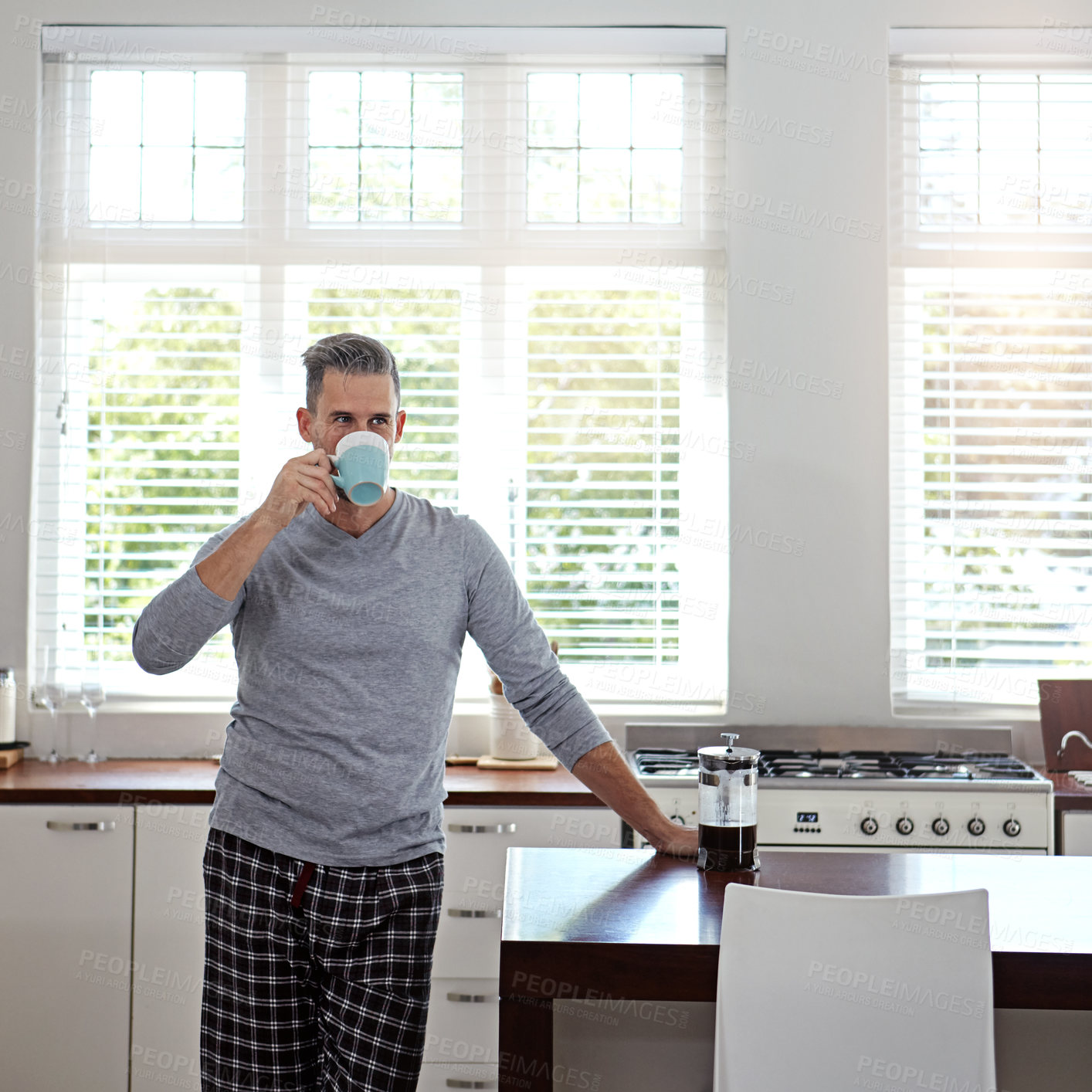 Buy stock photo Morning, home and man in kitchen with coffee to start day with caffeine beverage, warm drink and cappuccino. Apartment, relax and person with French press on counter for breakfast, aroma and espresso