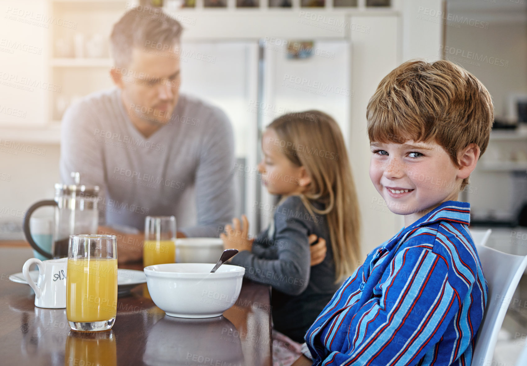 Buy stock photo Happy child, portrait or breakfast with family in kitchen for morning nutrition, vitamin C or orange juice at home. Father, kid or son with smile for meal, routine or healthy eating together at house