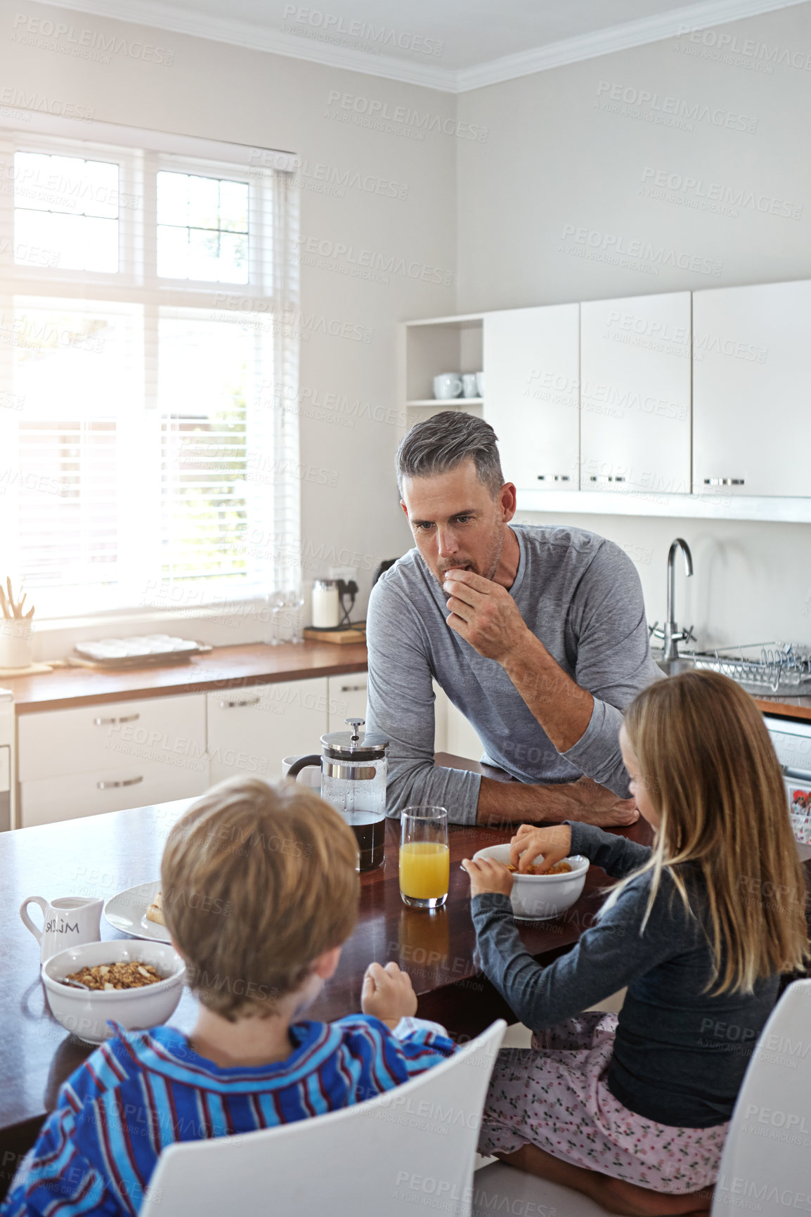 Buy stock photo Kitchen, eating and father with kids for breakfast together on weekend for nutrition at home. Happy, bonding and dad enjoying morning food with children for connection or family time in house.