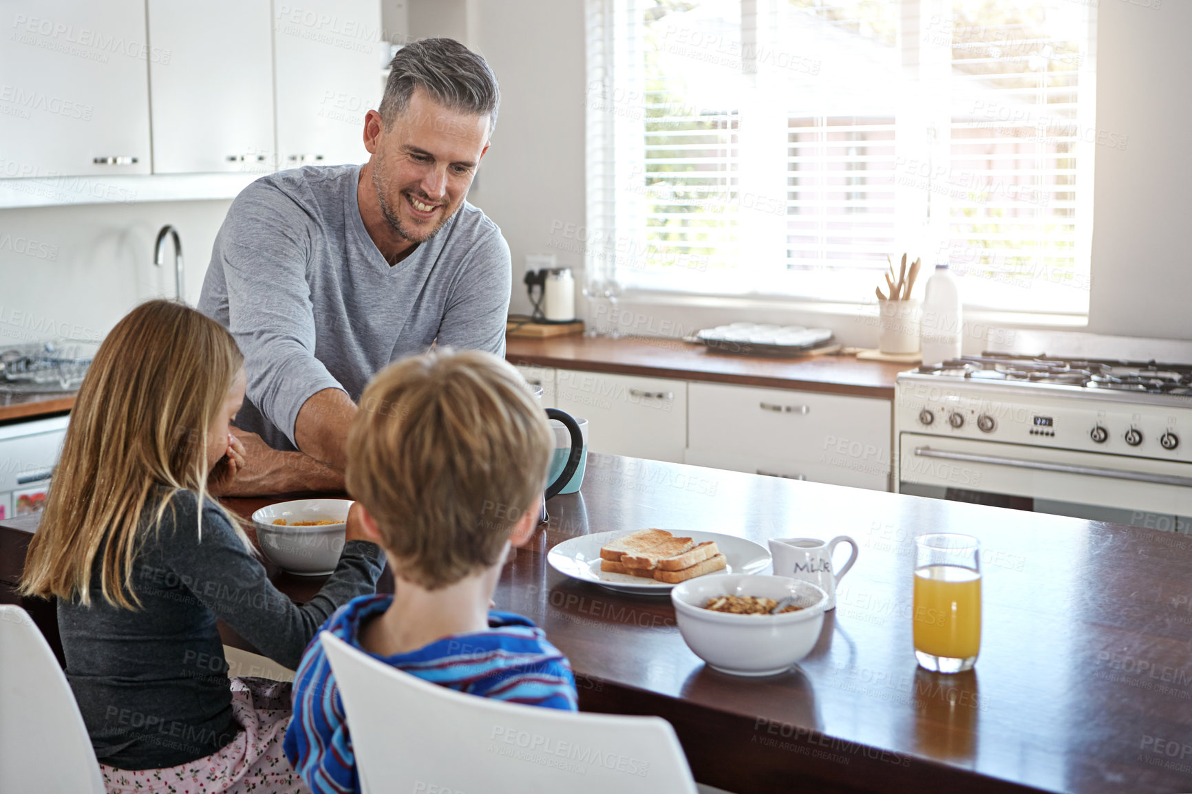 Buy stock photo Kitchen, eating and dad with children for breakfast together on weekend for nutrition at home. Happy, bonding and father enjoying morning food with kids for connection or family time in house.