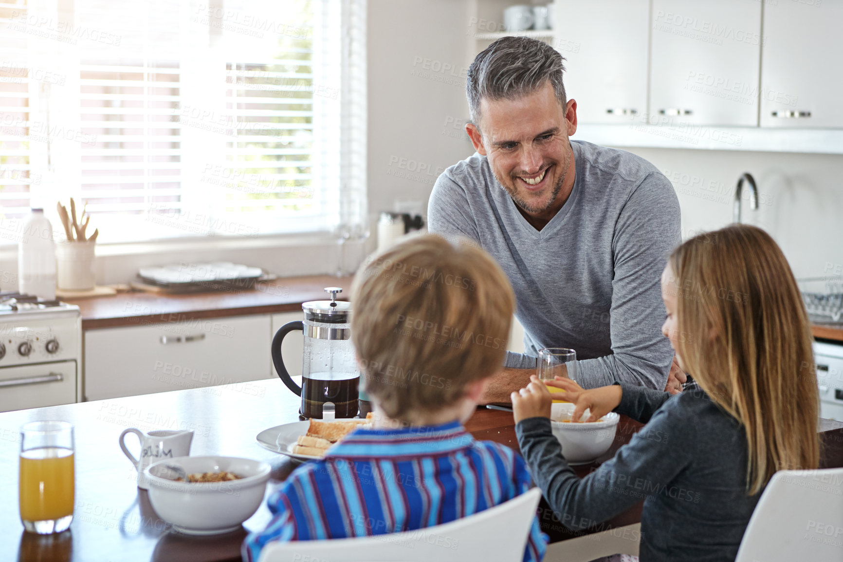 Buy stock photo Kitchen counter, dad and happy with kids for breakfast at home with conversation, support and care. Apartment, people and smile for family time in morning for meal, bonding and child development