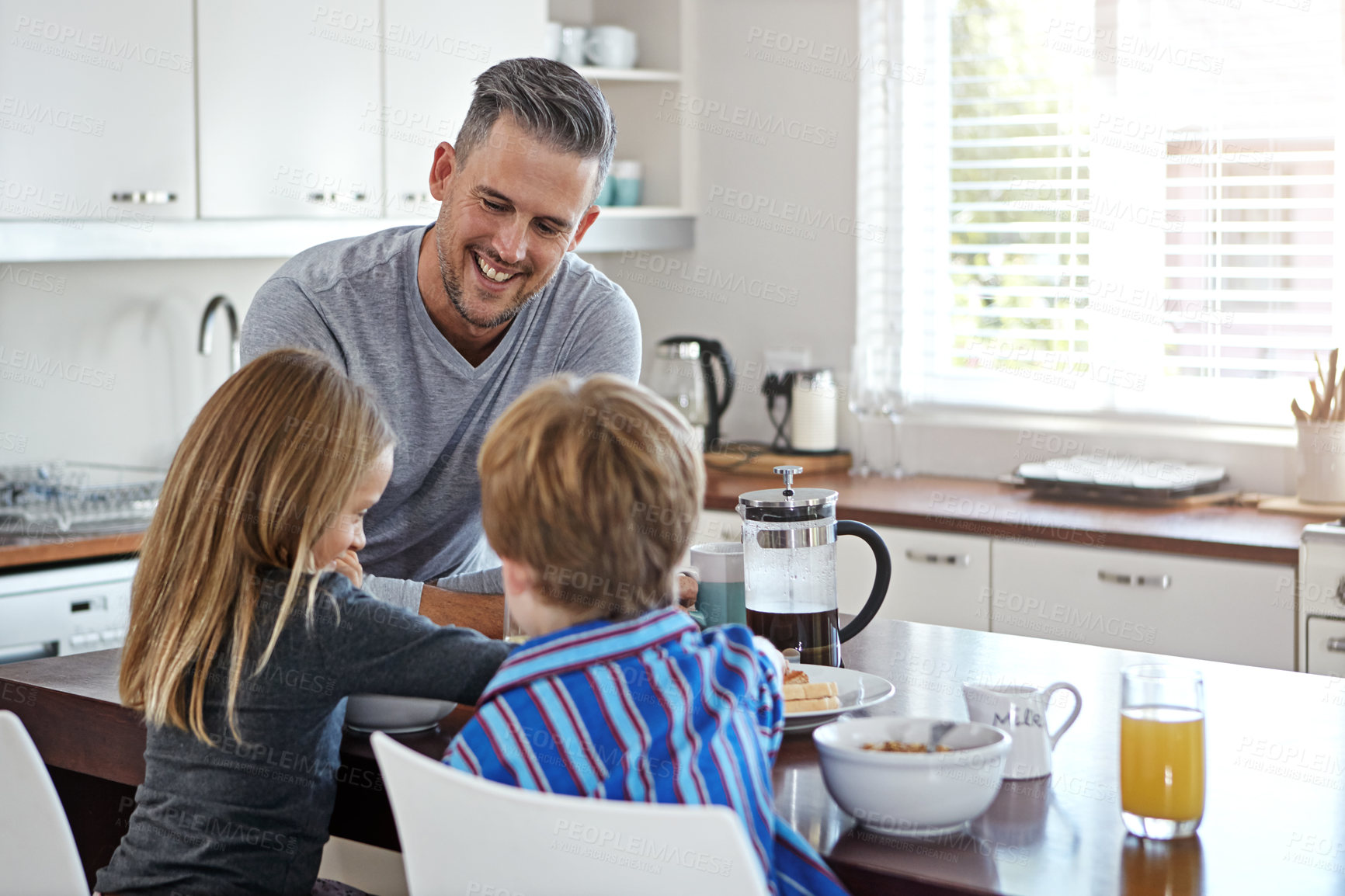 Buy stock photo Kitchen counter, father and smile with kids for breakfast in home with conversation, support and care. Apartment, people and happy for family time in morning for meal, bonding and child development