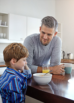 Buy stock photo Kitchen, eating and father with kid for breakfast together on weekend for nutrition at home. Happy, bonding and dad enjoying morning food with boy child for connection or family time in house.