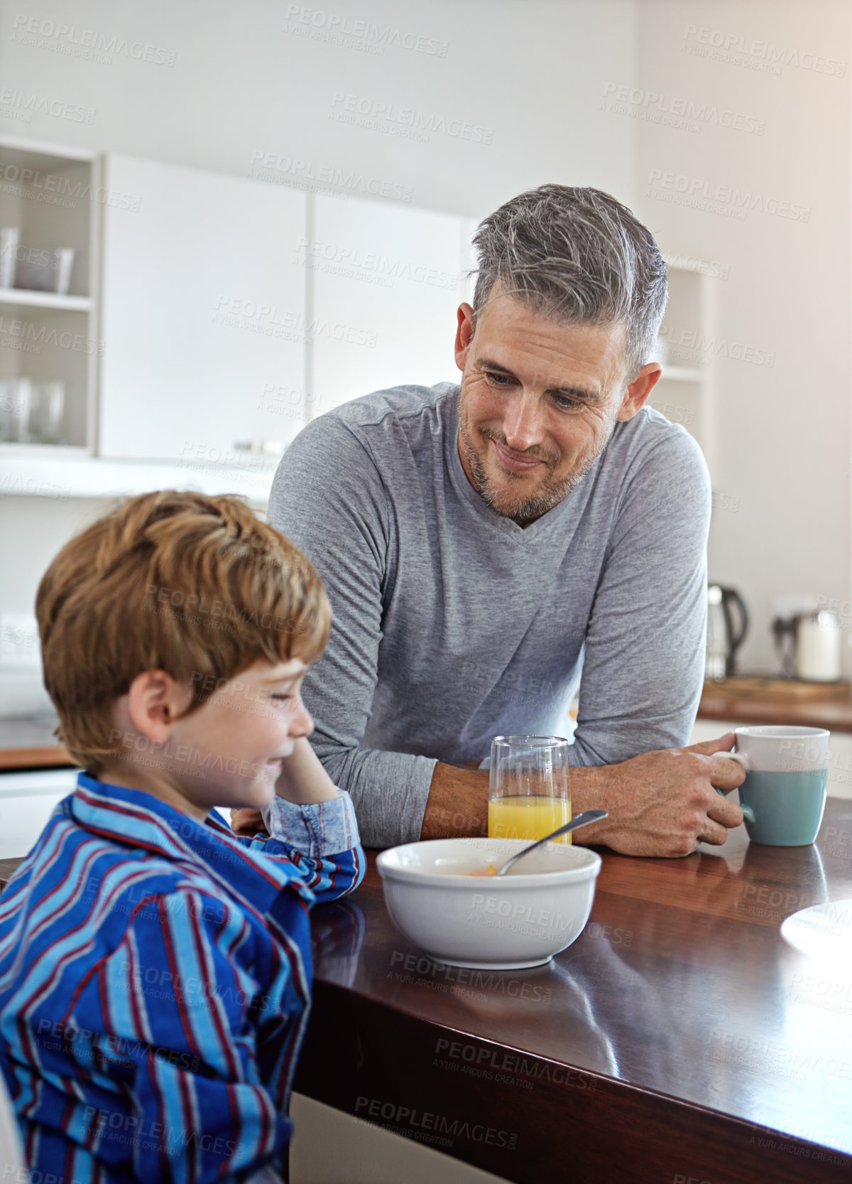 Buy stock photo Shot of a mid adult man and his son at home in the morning