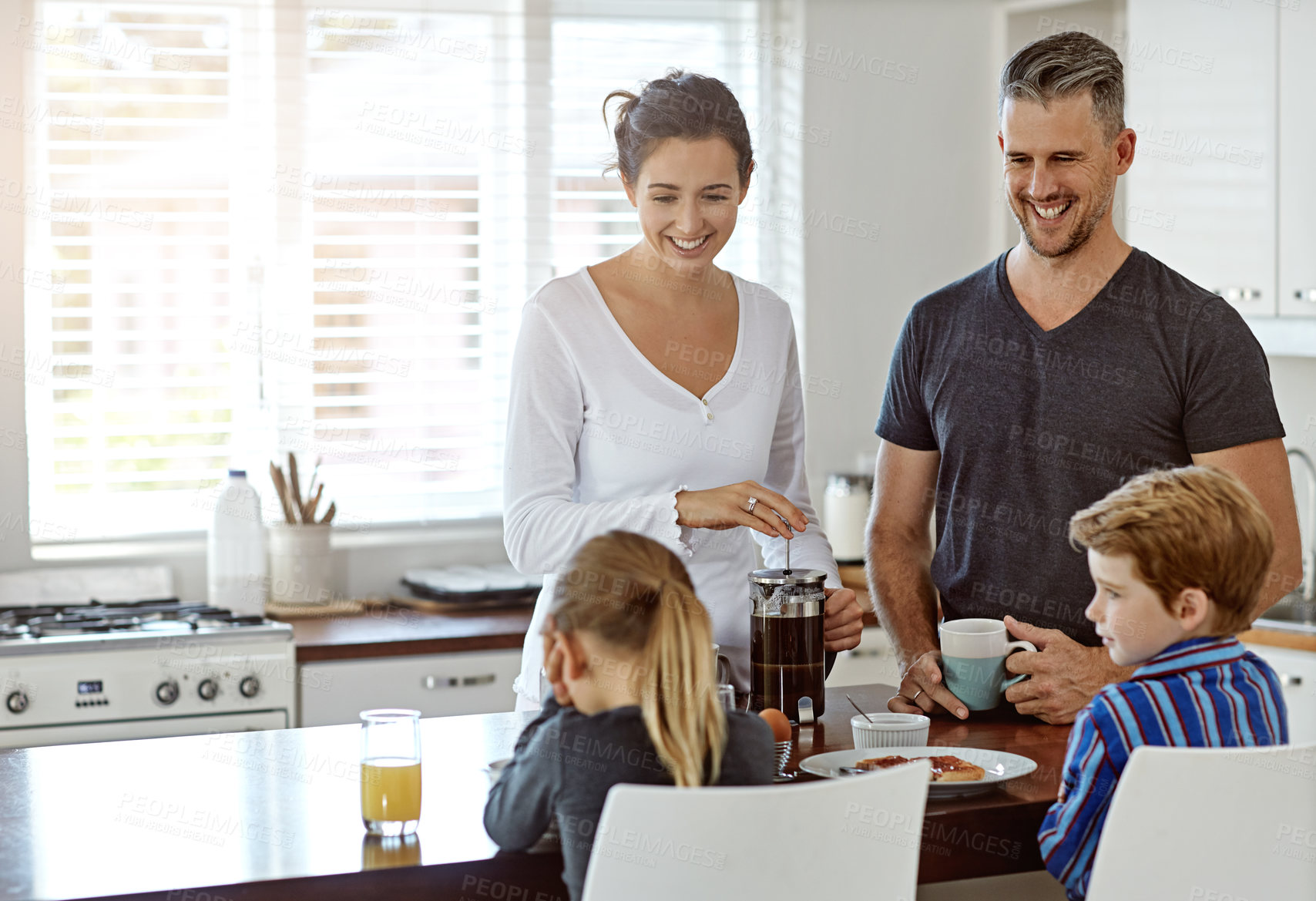 Buy stock photo Shot of a family having breakfast together