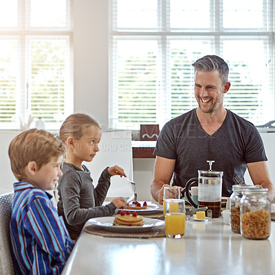 Buy stock photo Shot of a man enjoying breakfast with his two children