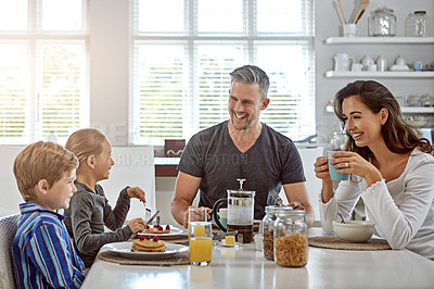 Buy stock photo Shot of a family having breakfast together