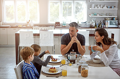 Buy stock photo Shot of a family having breakfast together