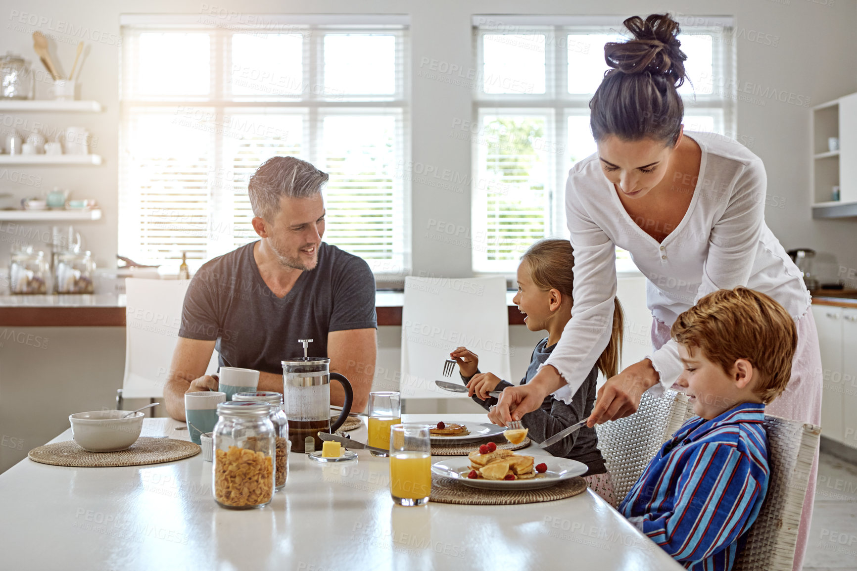 Buy stock photo Shot of a family having breakfast together