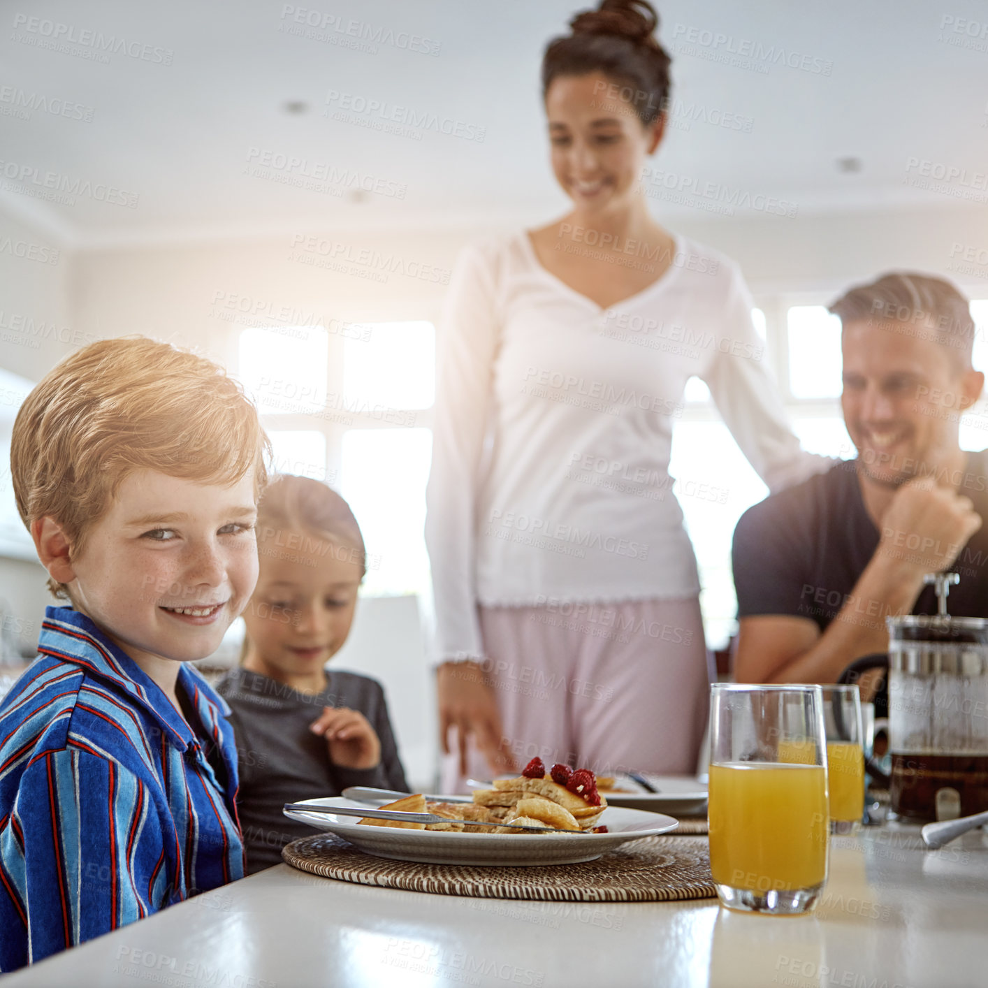 Buy stock photo Shot of a family having breakfast together