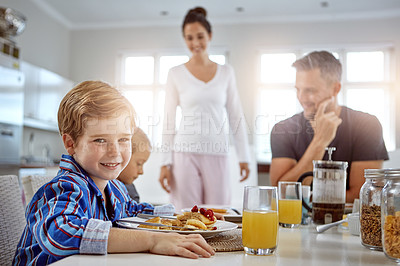Buy stock photo Child, portrait and pancakes for breakfast in a family home with love, care and happiness at a table. A happy woman, man and kids eating food together in morning for health, happiness and wellness