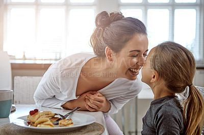 Buy stock photo Cropped shot of a mother and daughter having breakfast at home