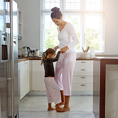 Buy stock photo Dance, love and mother with girl in kitchen play, fun and bonding, happy and relax in their home. Mom, daughter and dancing in their house, morning and playing while enjoying free day on the weekend